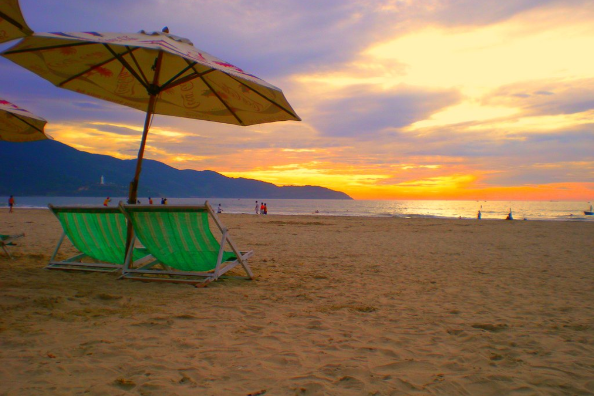 Beautiful sunset at My Khe Beach with golden sky reflections on the water